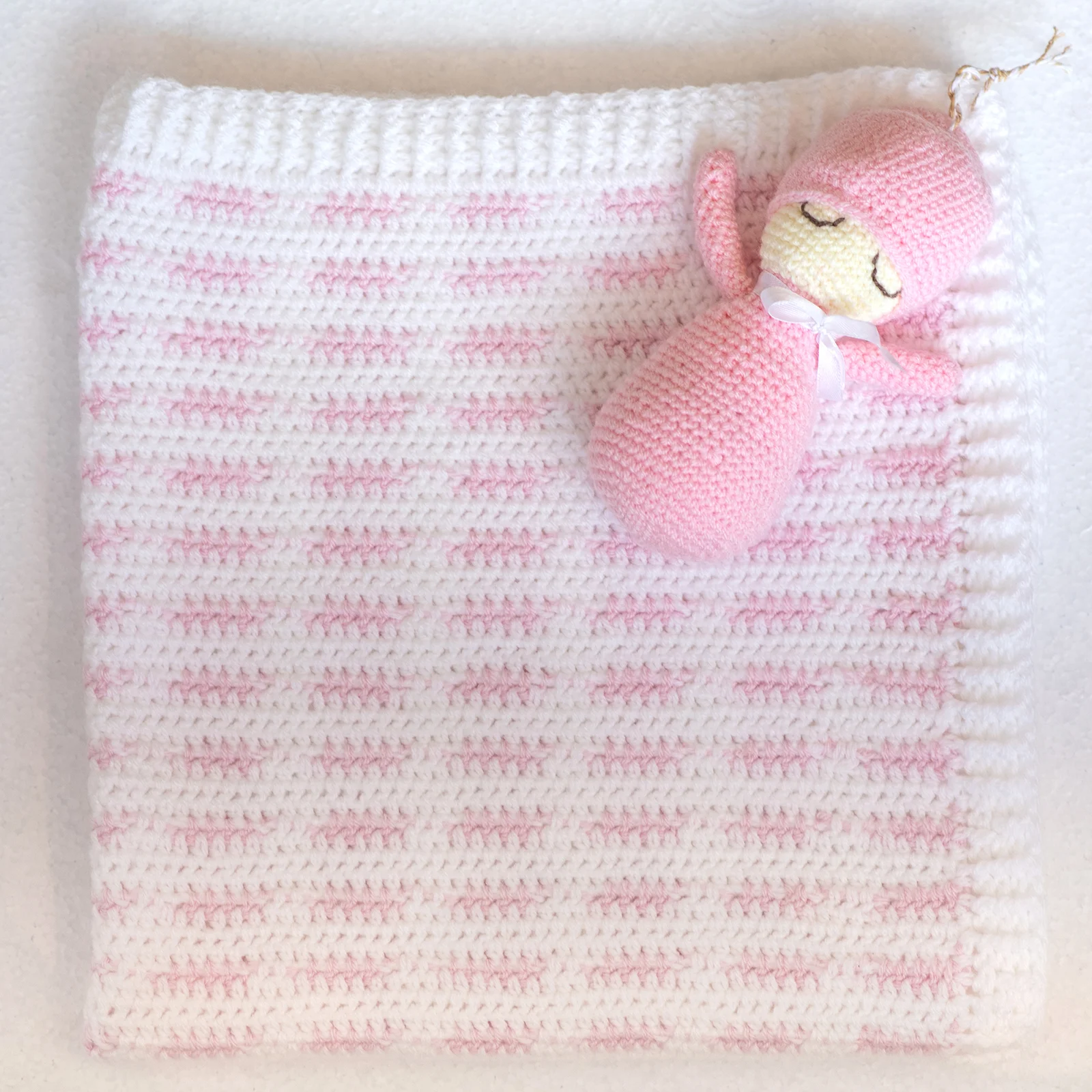 hand knitted pram blanket with doll
