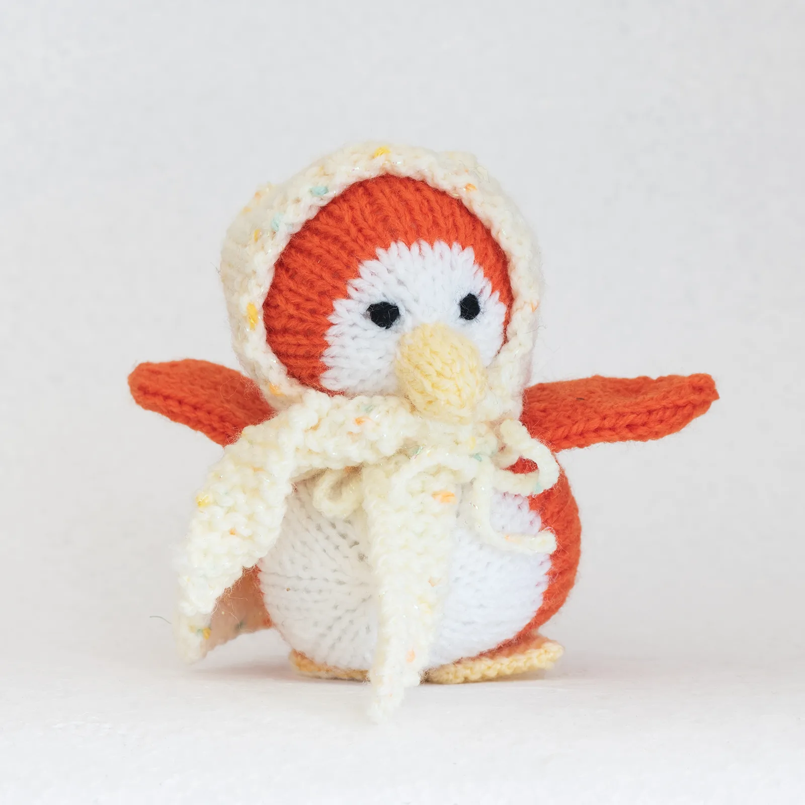 hand knitted duck with yellow cape